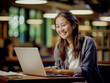 © Sran - Portrait of a woman studying in a cafe or library in front of her laptop