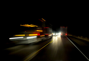 Interntionally blurred traffic on a two lane highway at night