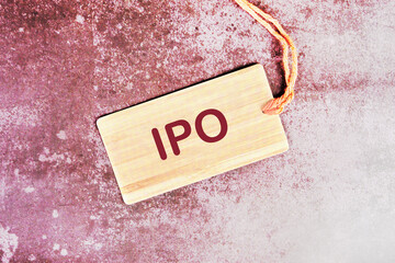 IPO word written on a card with a rope on an abstract background