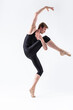© danmorgan12 - Male Ballet Dancer Man in Black Dance Suit Tights Posing in Ballanced Dance Pose While Stretching His Arm and Leg Muscles in Studio on White.