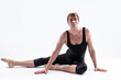 © danmorgan12 - Male Ballerino Dancer While Practising Stretching Exercices In Black Sportive Tights in Studio