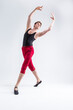 © danmorgan12 - Portrait of Concentrated Contemporary Ballet Dancer Flexible Athletic Man Posing in Red Tights in Ballanced Dance Pose With Hands Lifted