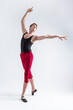 © danmorgan12 - Stretching of Concentrated Contemporary Ballet Dancer Flexible Athletic Man Posing in Red Tights in Ballanced Dance Pose With Hands Lifted