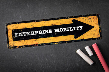 Wall Mural - Enterprise Mobility. Yellow directional arrow with text on a dark chalkboard background