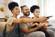 © Wesley/peopleimages.com - Interracial parents, child and watching tv on sofa, remote and choice for video, movie or show in living room. Father, mother and kid on lounge couch, comedy and streaming subscription in family home