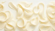 © AngrySun - White chocolate curls background. Flat lay composition. Generative AI