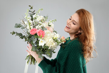 Sticker - Beautiful woman with bouquet of flowers on grey background