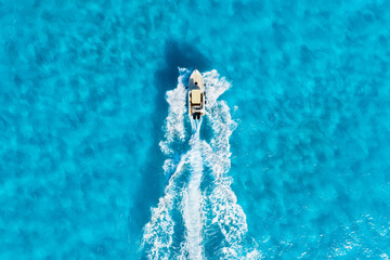 Wall Mural - vacation and leisure. aerial view on fast boat on blue mediterranean sea at sunny day. fast ship on 