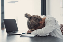 Exhausted Young Caucasian Female Employee Sleep Desk At Office Overwork Preparing Report. Tired Woman Fall Asleep Doze Off At Workplace, Work Late To Meet Deadline. Fatigue, Exhaustion Concept..