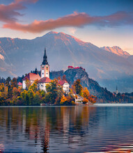 Attractive Morning View Of Pilgrimage Church Of Assumption Of Maria. Impressive Autumn Scene Of Bled Lake, Julian Alps, Slovenia, Europe. Traveling Concept Background.