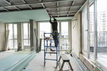 Construction worker installation ceiling work