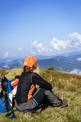 Wall Mural - girl tourist on the background of a mountain landscape