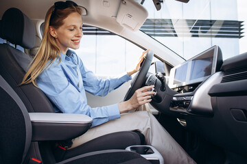 Woman sitting inside her new electric car