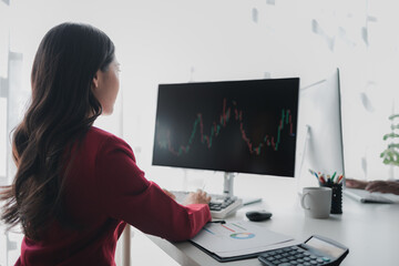 Asian woman looking at stock market graph screen, stock market businessman analyzing stock market rise and fall chart, stock market investor, profit making. investment concept.