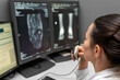 © ATRPhoto - radiology doctor examines foot, ankle x-ray, mr image and reports with microphone looking computer screen, X-ray analysis room reading X-rays of a heel, toe and other parts of the body.