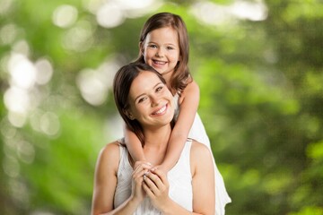 Wall Mural - Portrait of young happy mother with child in park