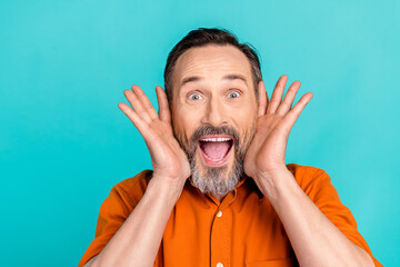 Poster - Photo of cheerful friendly impressed man with white gray beard wear stylish shirt staring at big sale isolated on teal color background