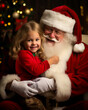 Santa Claus with a cute child on his lap, taking notes of Christmas wishes while sitting in his chair. Copy space and shallow field of view. 