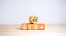 The Calendar Year 2024 With Goal And Success Concept. Big Wood Target Dart Icon And 2024 New Year Number On Wooden Cube Block Isolated On White Background. Happy New Year, Big Business Goals Banner.