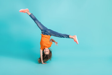 Wall Mural - Full length photo of active energetic girl wear trendy clothes playing standing arms v-sign empty space isolated on cyan color background