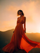 © Stefan - Fashion model on a mountaintop setting and a blue sky in an orange dress, Generative AI