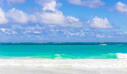 Wall Mural - Caribbean Sea shore waves are under blue sky on a sunny day