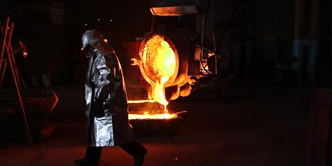 Wall Mural - Liquid iron molten metal pouring in container, industrial metallurgical factory, foundry cast, heavy industry 