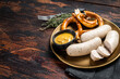 Munich white sausage with pretzel and mustard. Wooden background. Top view. Copy space