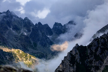 Wall Mural - sunlight on mountains in clouds