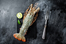 Raw Spiny Lobster Or Sea Crayfish On A Marble Board. Black Background. Top View