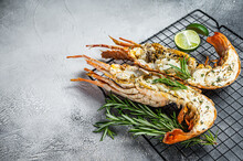 Barbecue Grilled And Sliced Spiny Lobster Or Sea Crayfish With Herbs. White Background. Top View. Copy Space