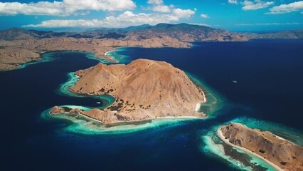 Wall Mural - Komodo National Park during sunny calm day, Flores island, Indonesia. Aerial view of the tropical islands and lagoons with turquoise water