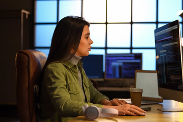 Young female programmer working in office