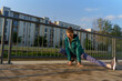 © Halfpoint - Attractive young woman stretching before her early morning run along the embankment of river.