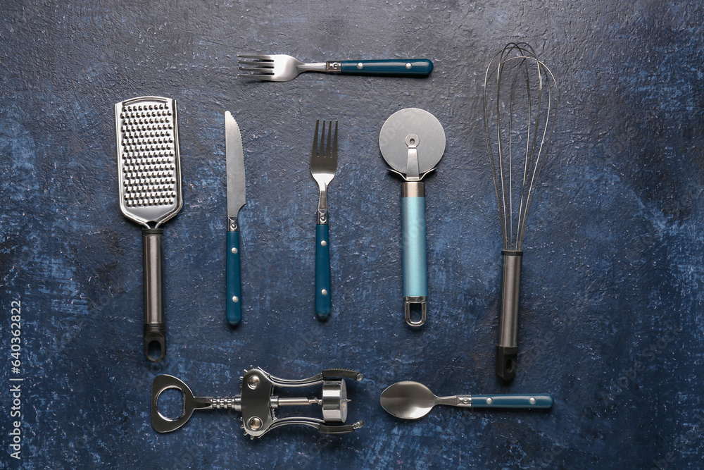Different kitchen utensils on blue background