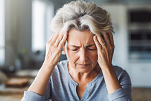 Mature Woman Suffering From Migraine. Older Woman Having A Headache And Holding Her Head In Pain.