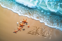 Aerial View Of Beautiful Tropical Beach And Ocean With Wave, Starfish And 2024 Written In Sand. Happy New Year Concept 