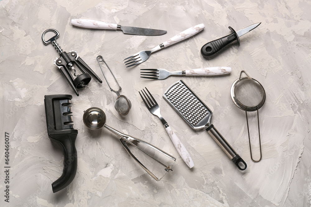 Different kitchen utensils on grey background