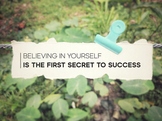 Inspirational quote - Believing in yourself is the first secret to success. Text on paper with nature background.

