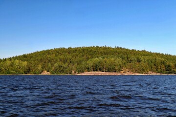 Wall Mural - Stone island overgrown with forest on Lake Ladoga in the Republic of Karelia