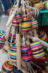 a picture of a group of a multicolor mexican balero, a typical mexican toy and a handcraft, taken in a marketplace,