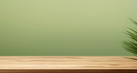 Wooden table top with green leaves on green wall background with copy space for product display. High quality photo