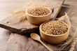 Whole wheat grain in bowl on wooden background, Food ingredients