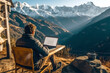 © AspctStyle - Young man traveler using laptop computer while enjoying beautiful snow mountain during summer journey. Male freelance working on his laptop during summer vacation holidays. Freelance lifestyle concept