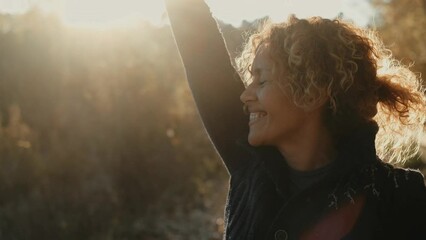 Sticker - Portrait of cheerful adult cute woman outdoor at the park smiling and enjoying sunset autumn golden hour moment. Happy people in the nature. Curly joy female people closing eyes and feel emotions