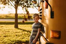Kindergarten Aged Child Leaning Against School Bus For Back To S