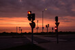 Traffic lights in the dramatic light against red Sunset sky