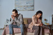 © LIGHTFIELD STUDIOS - abortion concept, man sitting on bed near african american woman with pregnancy test, worried couple