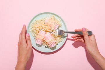 Wall Mural - Noodles, curlers and female hands on pink background, top view