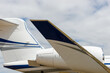 White and blue private jet, tail wing and fuselage